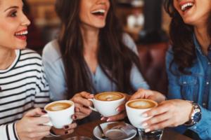 Friends smiling and enjoying coffee